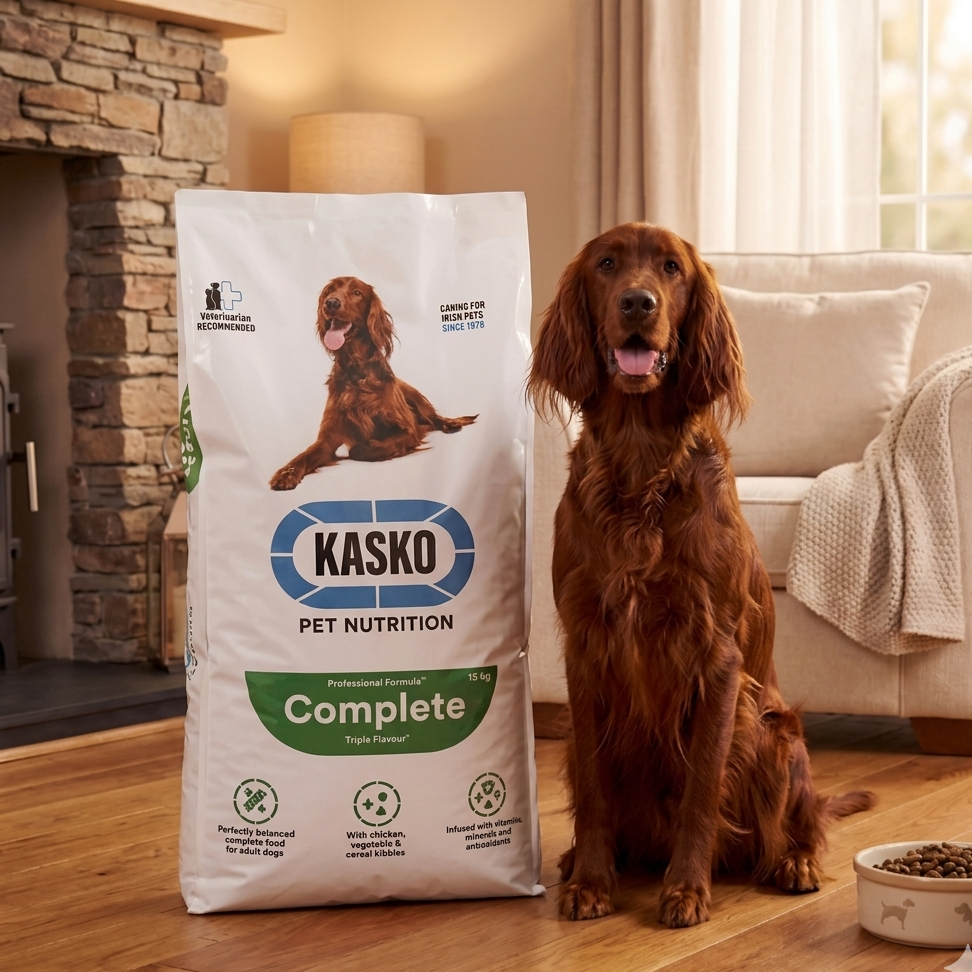 Dog standing next to a bag of Kasko Pet Nutrition Complete dog food in a home setting.